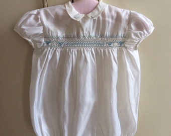 Vintage 1950s child or baby white romper suit with smocking.
