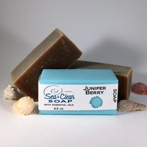 May include: Two bars of brown soap with a blue label that reads "Sea & Clean Soap with Essential Oils 4.5 oz. Juniper Berry Soap".