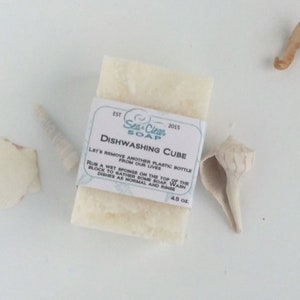 May include: White dishwashing soap cube with a label that reads "Sea Clean Soap" and "Dishwashing Cube". The label also includes instructions for using the soap and the text "EST 2015" and "4.5 oz."