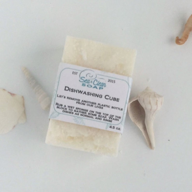 May include: White dishwashing soap cube with a label that reads "Sea Clean Soap" and "Dishwashing Cube". The label also includes instructions for using the soap and the text "EST 2015" and "4.5 oz."