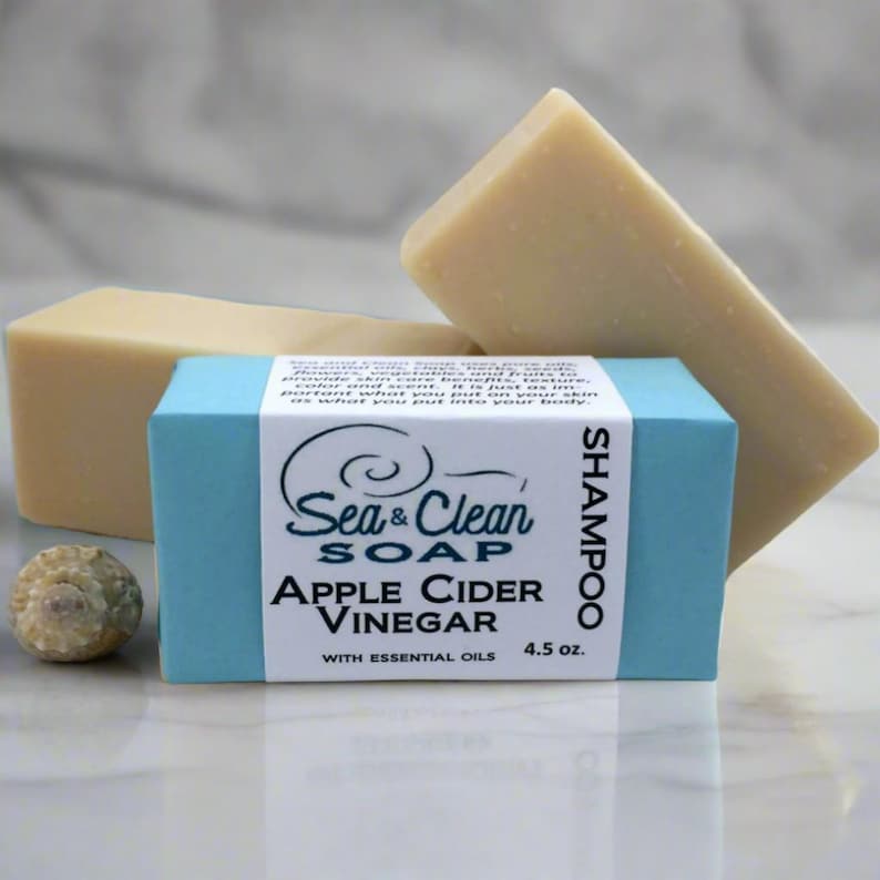 May include: A blue box with white text that reads "Sea & Clean Soap Apple Cider Vinegar with Essential Oils 4.5 oz."  The box contains a bar of natural soap shampoo.