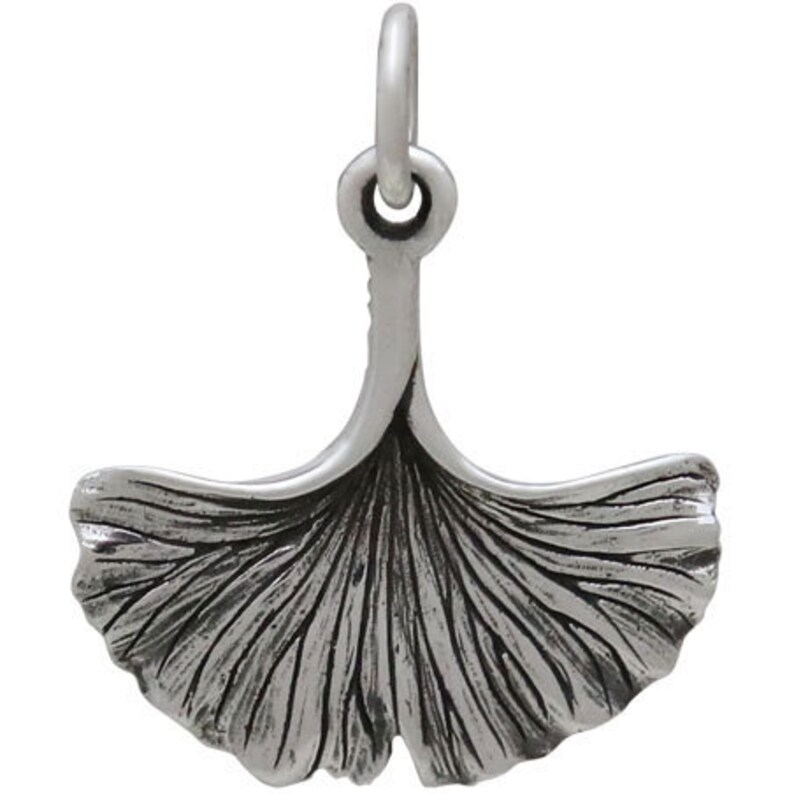 May include: A silver charm in the shape of a ginkgo leaf. The leaf is detailed with veins and has a loop at the top for attaching to a bracelet or necklace.
