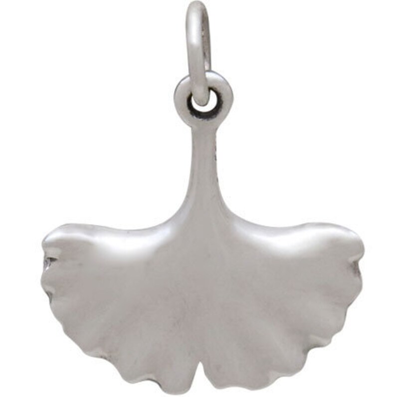 May include: A silver charm in the shape of a ginkgo leaf. The charm has a loop at the top for attaching to a bracelet or necklace.