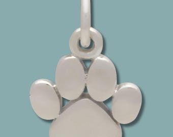 May include: A silver paw print charm with a loop for attaching to a necklace or bracelet. The charm features a detailed paw print design, ideal for pet owners. The charm is made of a shiny metal.