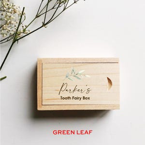 May include: A wooden box with a green leaf design and the text "Parker's Tooth Fairy Box" engraved on the lid.