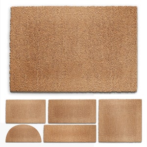 May include: A set of brown coir doormats in various shapes and sizes. The mats are made from natural fibres and have a rough texture.