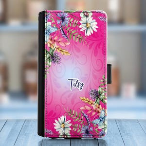 May include: A pink phone case with a floral design and the name "Tilly" printed on it.