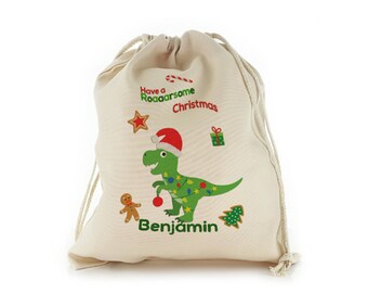 Saco de regalo de Navidad personalizado con diseño de dinosaurio en una bolsa con cordón, gran media con nombre agregado