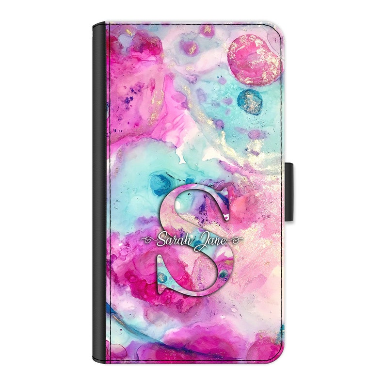 May include: A pink, blue, and gold abstract watercolor phone case with a cutout letter "S" and the text "Sarah Jane".