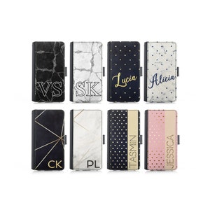 May include: Eight different phone cases with various patterns and designs. The cases feature black and white marble, black and gold geometric patterns, black and white polka dots, and pink and gold polka dots. Each case has a name printed on it, including "VS", "SK", "Lucia", "Alicia", "CK", "PL", "Jasmin", and "Jessica".