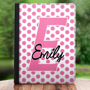 May include: Pink and white polka dot tablet case with a large pink letter E and the name "Emily" in black cursive writing.