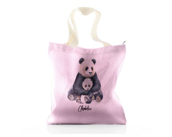 May include: Pink canvas tote bag with a white handle and a printed image of two pandas. The text "Chloë" is printed on the bag.