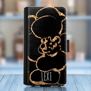 May include: Black phone case with a gold glitter floral design and the name "LEXI" printed in white.