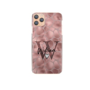 May include: A rose gold phone case with a textured pattern and a black letter "W" with the name "William" and a small heart.