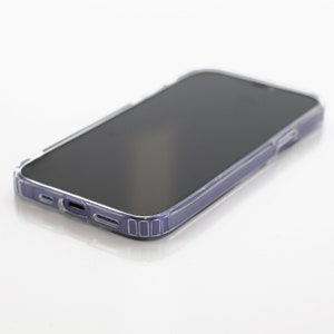 a close up of a cell phone on a white surface