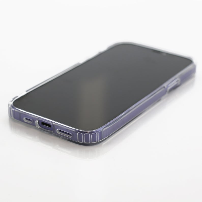 a close up of a cell phone on a white surface