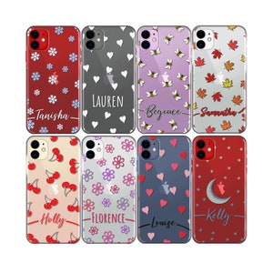 May include: Eight different phone cases with various patterns and names. The cases are clear and show the phone's design underneath. The patterns include snowflakes, hearts, bees, leaves, cherries, flowers, hearts, and stars.
