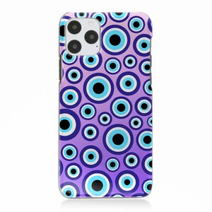 May include: Purple phone case with a pattern of blue and white evil eyes. The case has a cutout for the camera lens.