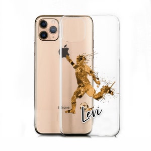 May include: A clear phone case featuring a gold silhouette of a football player kicking a ball. The player is surrounded by gold paint splatters. The name "Levi" is printed in black on the case.