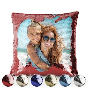 May include: A square sequin pillow with a photo of a woman and child. The pillow's sequins are red, and the photo is visible when the sequins are flipped. The pillow has a light blue background. Several color options are shown at the bottom.