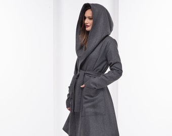 May include: A gray hooded wrap coat with a tie belt and pockets. The coat is made of a soft, warm fabric and has a relaxed fit.