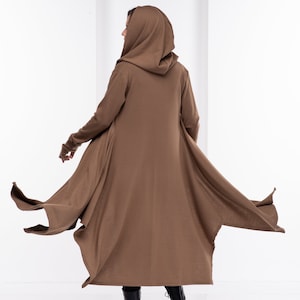 Long hooded cloak with side pockets, and long sleeves with thumb-holes. Extravagant asymmetrical design made from mid-weight knitted fabric. Perfect for your everyday outfit, or a special costume occasion for a cardigan robe.