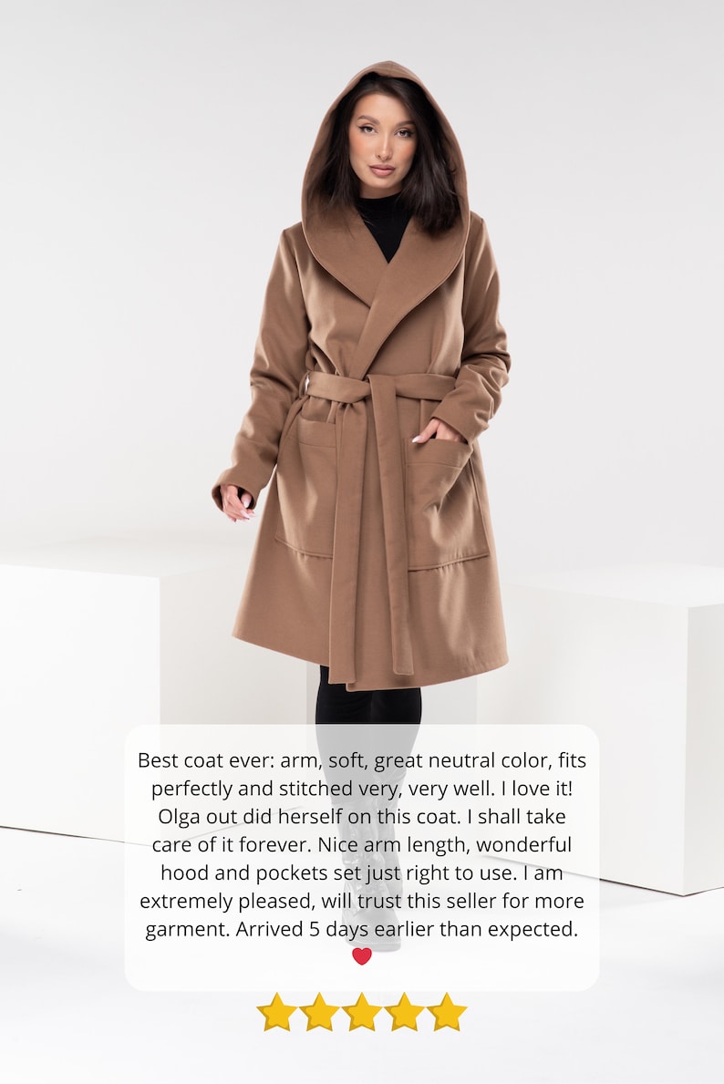 May include: A brown hooded wrap coat with a tie belt. The coat has two pockets and is shown on a model. The text "Best coat ever: arm, soft, great neutral color, fits perfectly and stitched very, very well. I love it! Olga out did herself on this coat. I shall take care of it forever. Nice arm length, wonderful hood and pockets set just right to use. I am extremely pleased, will trust this seller for more garment. Arrived 5 days earlier than expected." is below the model.