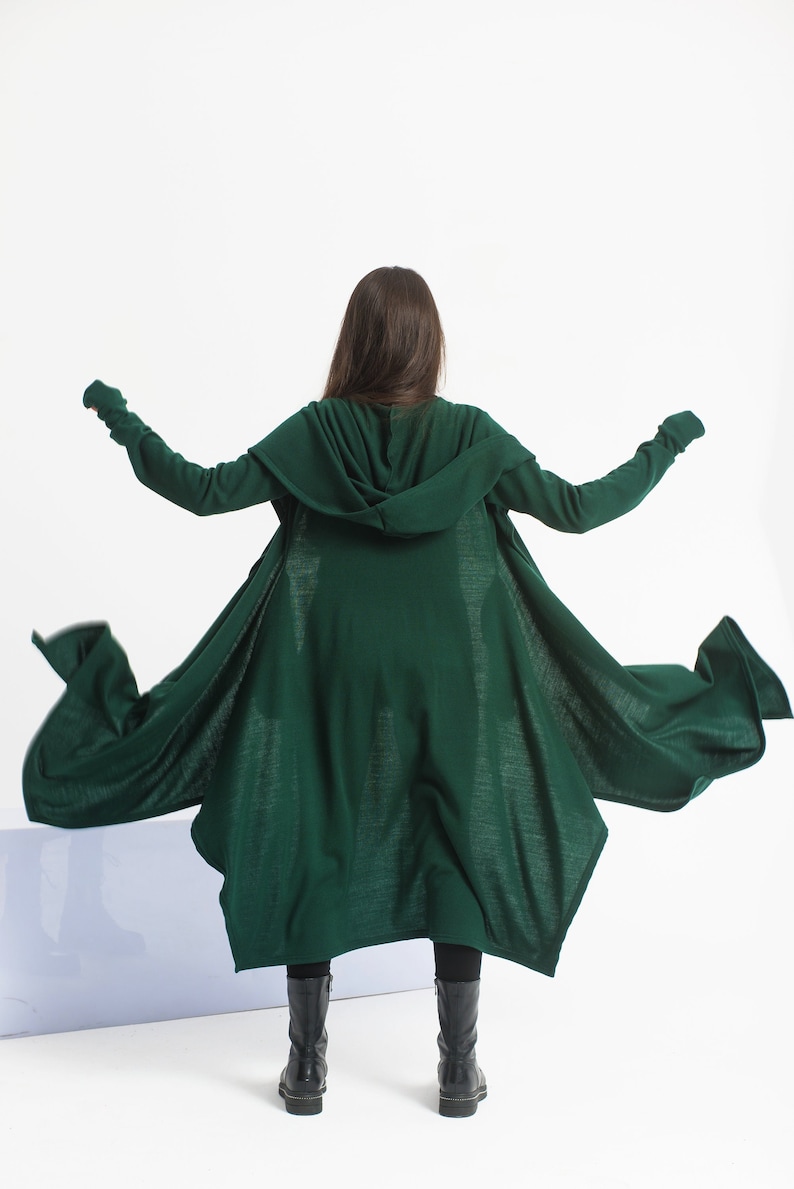 Long hooded cloak with side pockets, and long sleeves with thumb-holes. Extravagant asymmetrical design made from mid-weight knitted fabric. Perfect for your everyday outfit, or a special costume occasion for a cardigan robe.