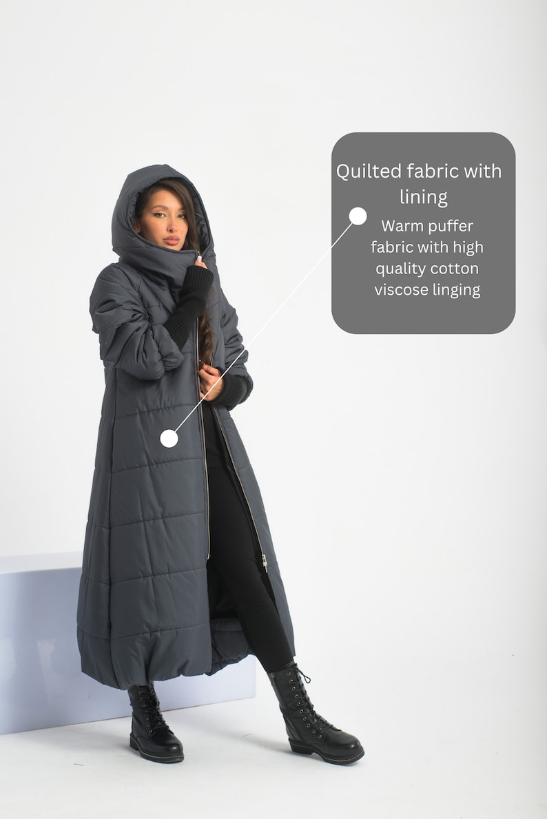 May include: A long, dark blue quilted coat with a high collar and a zip closure. The coat has a warm puffer fabric with high quality cotton viscose lining.  "Quilted fabric with lining" and "Warm puffer fabric with high quality cotton viscose lining" are written in white text on a grey background.