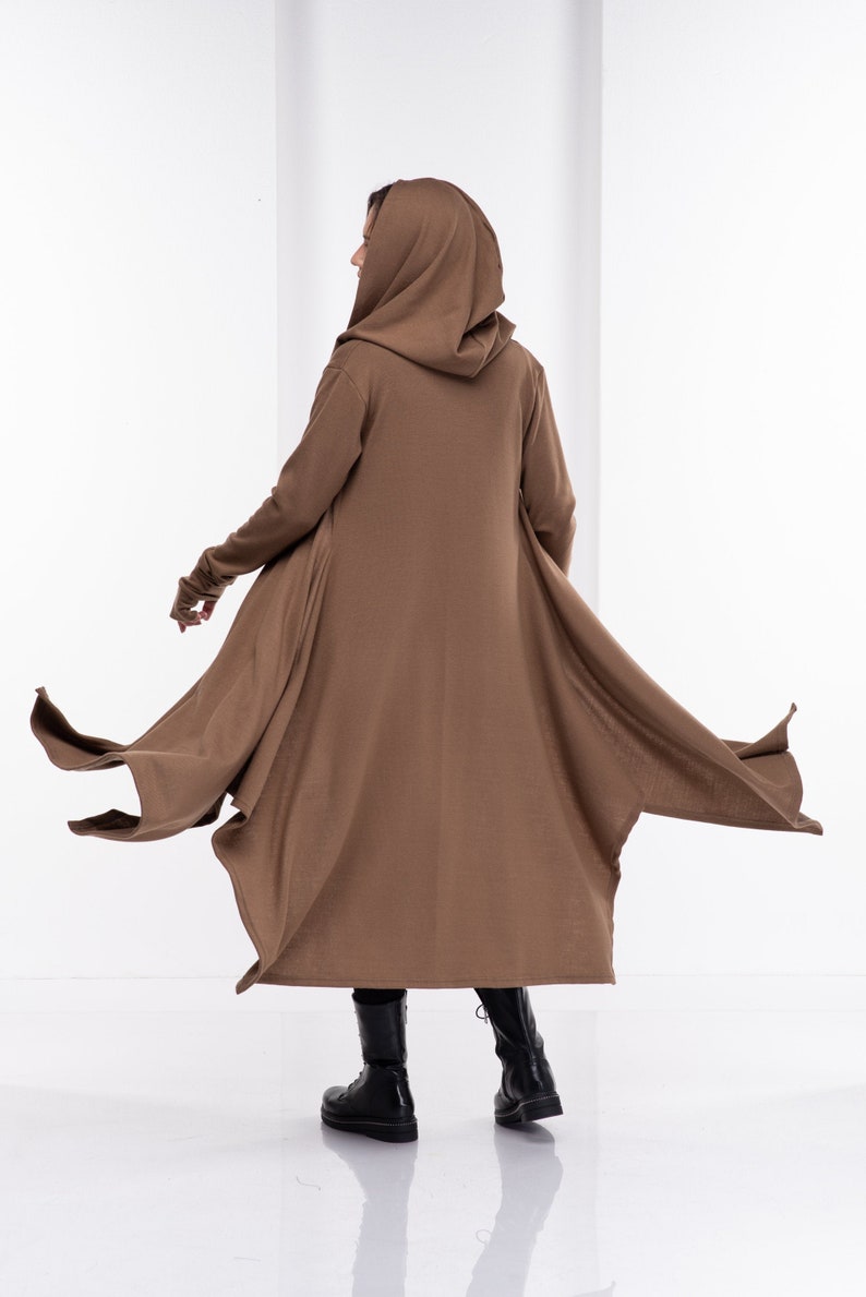Long hooded cloak with side pockets, and long sleeves with thumb-holes. Extravagant asymmetrical design made from mid-weight knitted fabric. Perfect for your everyday outfit, or a special costume occasion for a cardigan robe.