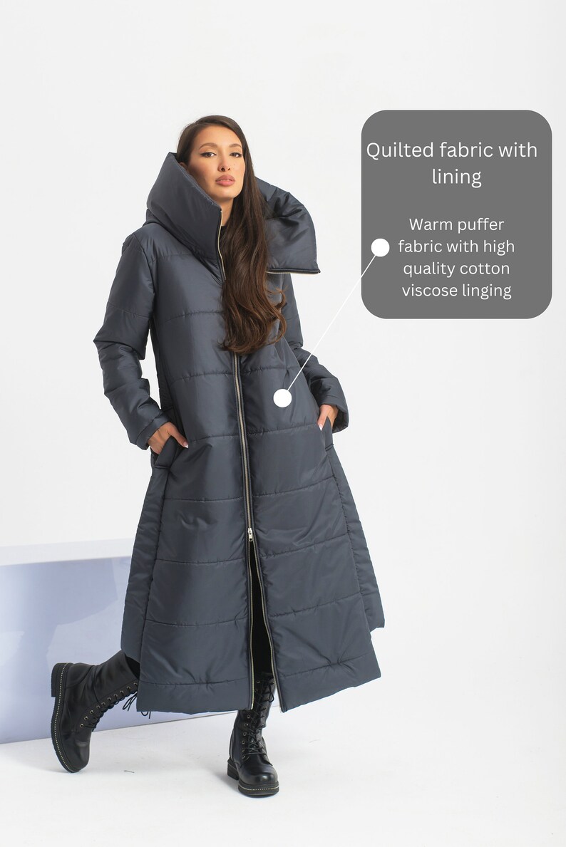 May include: A long, dark blue quilted puffer coat with a high collar and a zipper closure. The coat has a warm puffer fabric with high quality cotton viscose lining.