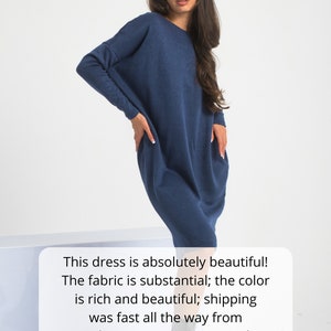 May include: A navy blue long-sleeved dress with a relaxed fit. The dress is made of a soft, substantial fabric. The model is wearing the dress with black ankle boots. The text in the image reads: "This dress is absolutely beautiful! The fabric is substantial; the color is rich and beautiful; shipping was fast all the way from Bulgaria! Can't recommend enough!"