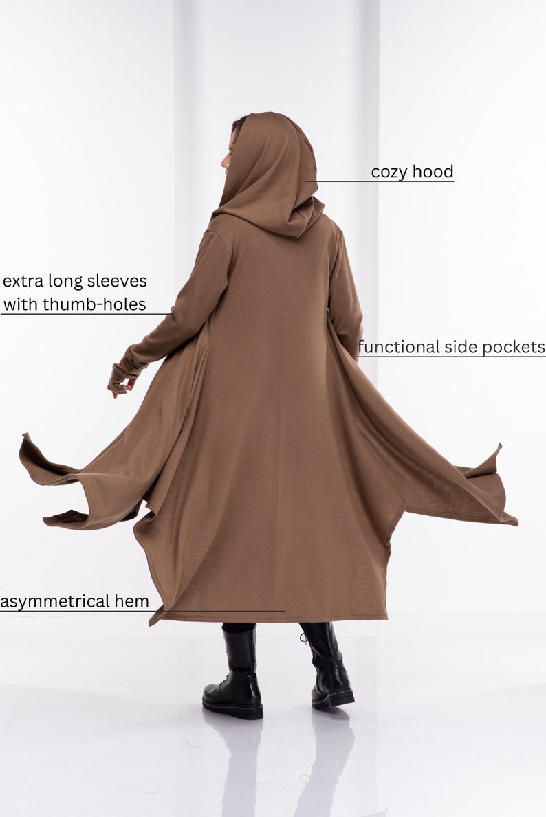 May include: A brown hooded cardigan with extra long sleeves and thumb holes. The cardigan has a cozy hood, functional side pockets, and an asymmetrical hem.