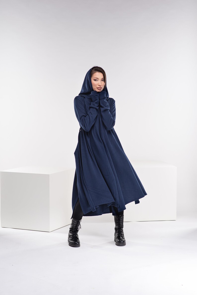 May include: A long, navy blue hooded dress with a flowing skirt. The dress is made of a soft, comfortable fabric and has a relaxed fit.