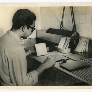 Young man testing seeds- original vintage 1960s photo- agriculture- guy at working at desk- United Nations FAO photo- Rockefeller foundation