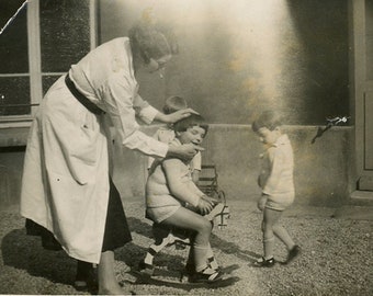 Vintage photo 'Head Adjustment' vernacular photos snapshot, little children girls toddlers, kindergarten, rocking horse