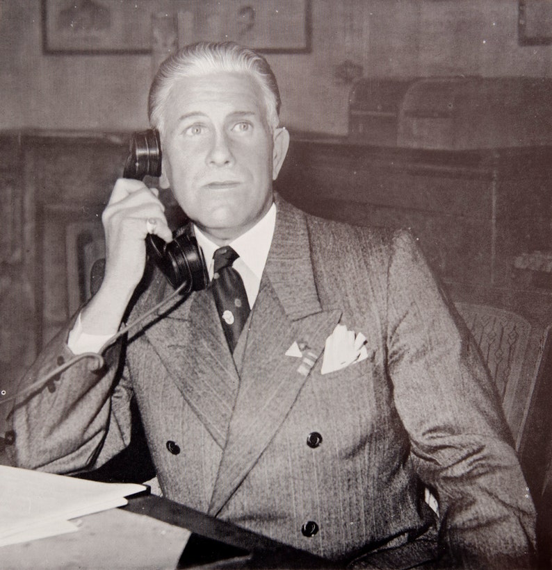 portrait of a man sharply dressed in a suit with telephone The call vintage lithographic photo print