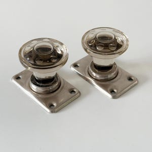Pair of vintage glass door handles on the metal base. Made in the USSR. Clear glass door knobs