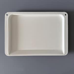 May include: A rectangular, off-white enamel tray with rounded corners and a slightly raised edge. Two small holes are visible on opposite corners. The tray is set against a gray background, highlighting its clean lines and simple design.