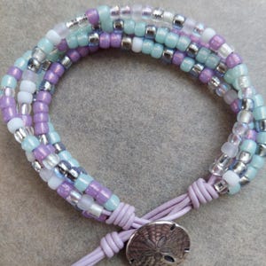 Beaded bracelet with light purple leather cord and sand dollar button, fits 6.75 inch wrist, gift for her