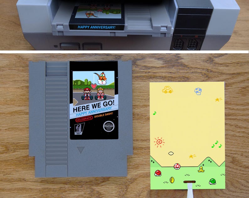 A greeting card is made from a reproduction NES cart with a glossy label. Art shows Mario and Peach ready to race with Lakitu holding a heart overhead in a scene from Mario Kart. A flat card pulls art from the title screen with items on the ground.