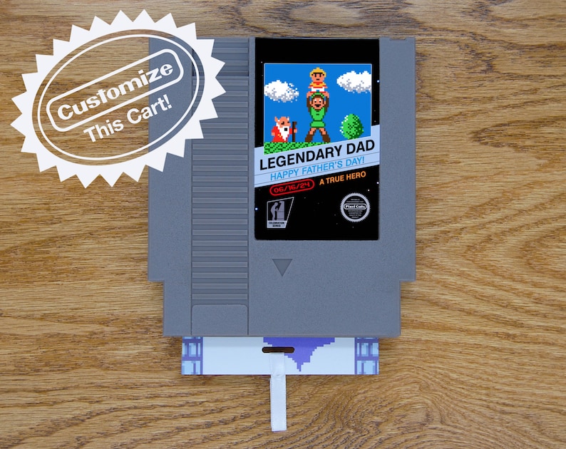A Father’s Day greeting card is made from a reproduction NES cart. It has a glossy label and a flat card that goes inside the game cart with a ribbon attached. Label art Link holding up a child with an old man next to him.