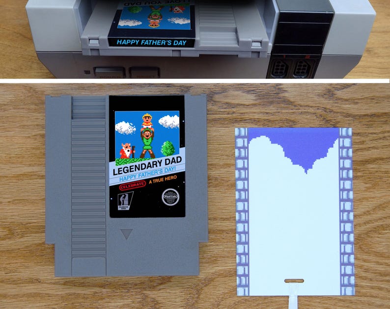 May include: A custom Nintendo Entertainment System (NES) game cartridge with a blue and white label that reads "Legendary Dad Happy Father's Day Celebrate A True Hero". The label features a pixelated image of a father and son in a video game style.