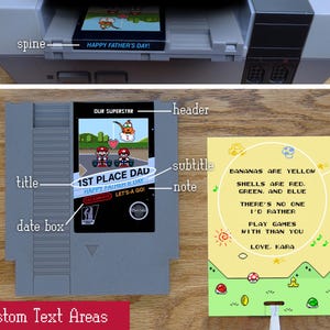 May include: A gray video game cartridge with the text "1ST PLACE DAD" and "HAPPY FATHER'S DAY!" A yellow insert card features a poem about playing games. The console reads "HAPPY FATHER'S DAY!"