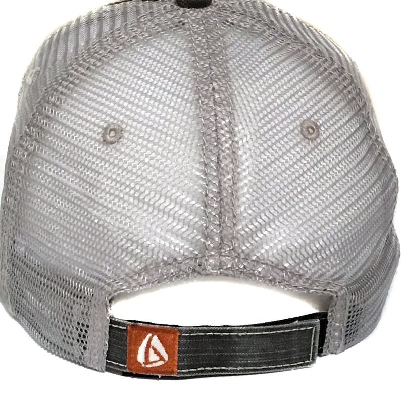 May include: Gray mesh trucker hat with a black and orange logo on the back.