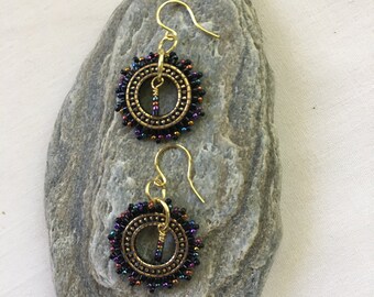 Earrings featuring handbeaded gold plated pewter rings with tiny metallic beads. Brass ear wires