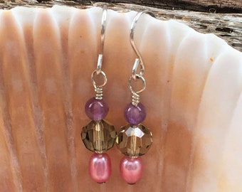 Handmade earrings with Swarovski crystals, freshwater pearls, and amethyst beads. Sterling silver ear wires