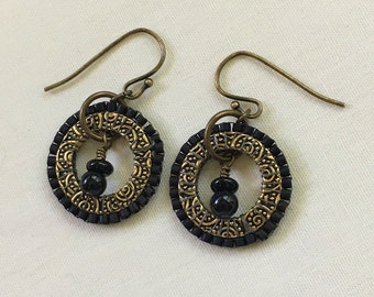 Earrings made with handbeaded gold plated pewter rings and tiny glass beads. Onyx dangles  and antique brass ear wires.