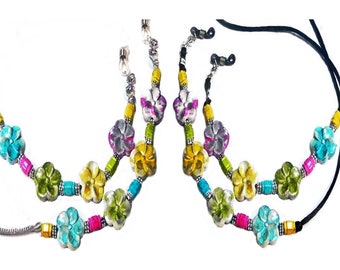 May include: Two pairs of colorful beaded eyeglass chains. Each chain has a black cord and silver metal clasps. The beads are in the shape of flowers and are in shades of turquoise, yellow, green, pink, and purple.