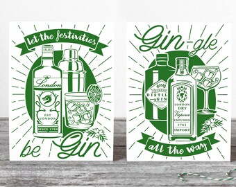 May include: Two white greeting cards with green ink illustrations. The left card features a gin bottle, shaker, and glass with the text let the festivities be Gin. The right card shows a gin bottle and glass with the text Gin-gle all the way.